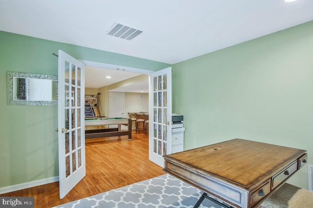 office area with french doors and hardwood / wood-style flooring