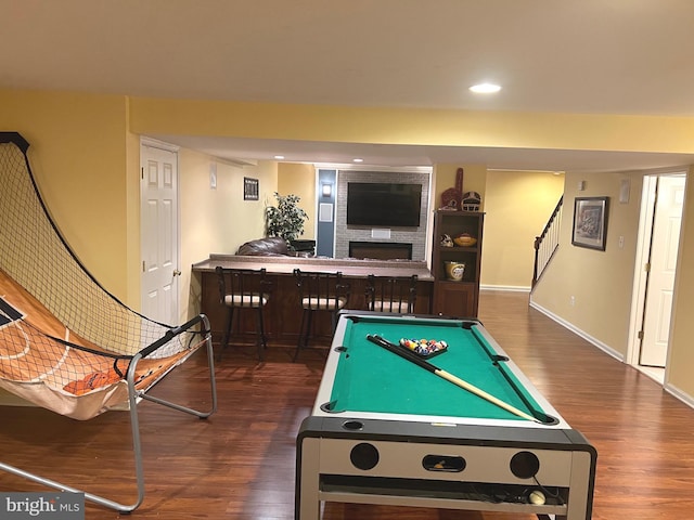 playroom with dark wood-type flooring, bar area, and billiards