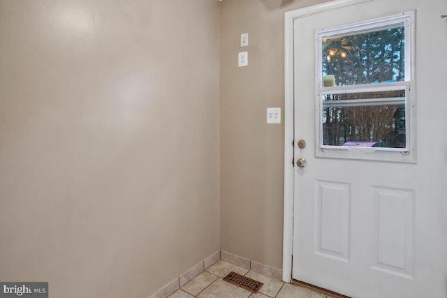 doorway with light tile patterned floors