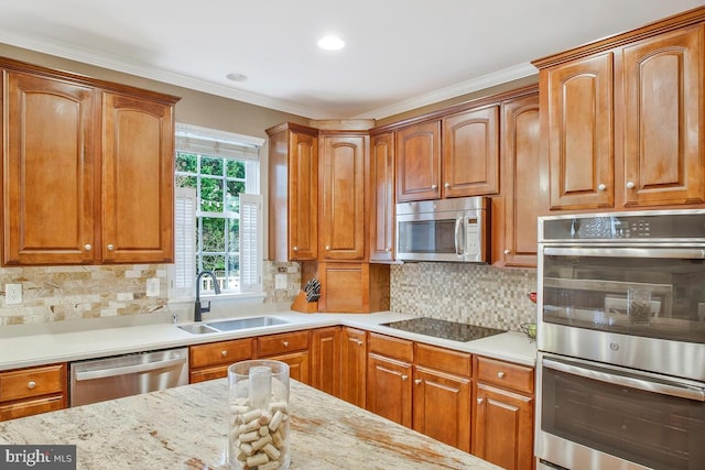 kitchen featuring sink, appliances with stainless steel finishes, backsplash, ornamental molding, and light stone countertops