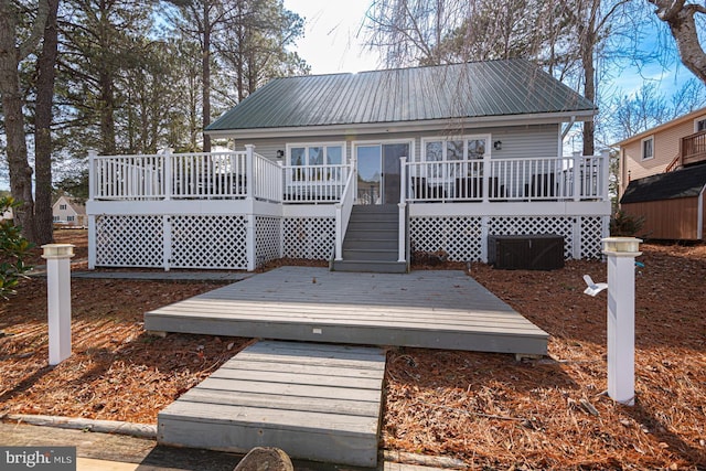 rear view of property featuring a deck