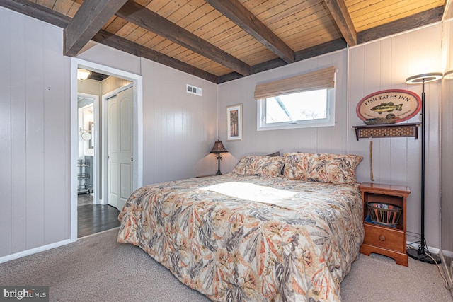 bedroom with beamed ceiling, carpet flooring, and wooden ceiling