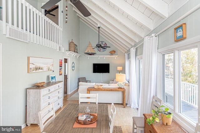 living room with beam ceiling, high vaulted ceiling, and ceiling fan