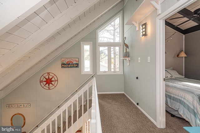 hall featuring lofted ceiling and carpet