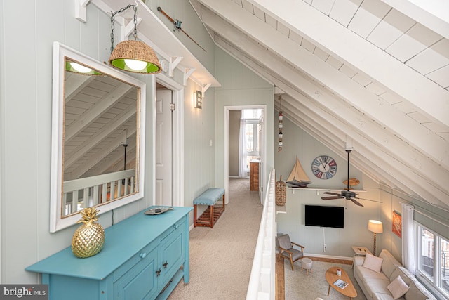 interior space with vaulted ceiling and light colored carpet