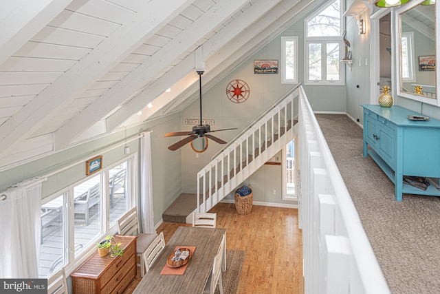 living room with wood ceiling, light hardwood / wood-style floors, and vaulted ceiling with beams