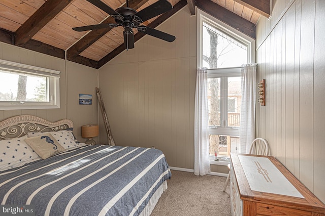 carpeted bedroom with vaulted ceiling with beams, wood ceiling, wooden walls, and ceiling fan