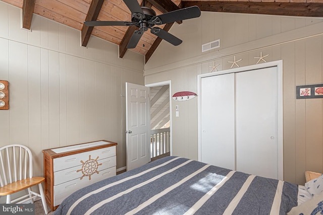 bedroom with wood ceiling, lofted ceiling with beams, a closet, and ceiling fan