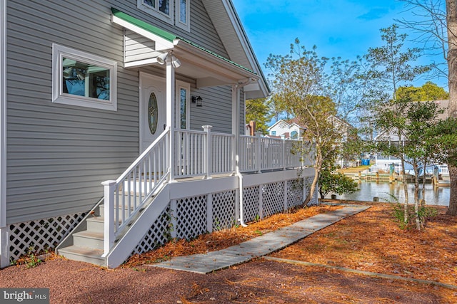 entrance to property with a water view