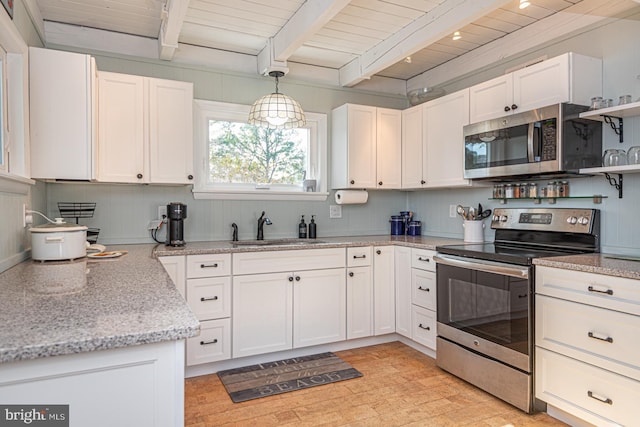 kitchen featuring pendant lighting, sink, white cabinets, stainless steel appliances, and beam ceiling