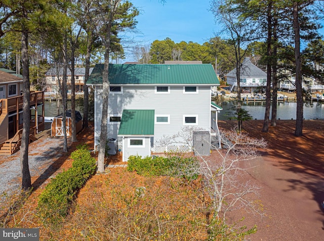 rear view of property featuring a water view