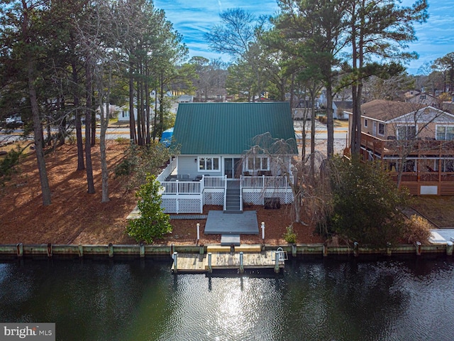 back of house featuring a deck with water view