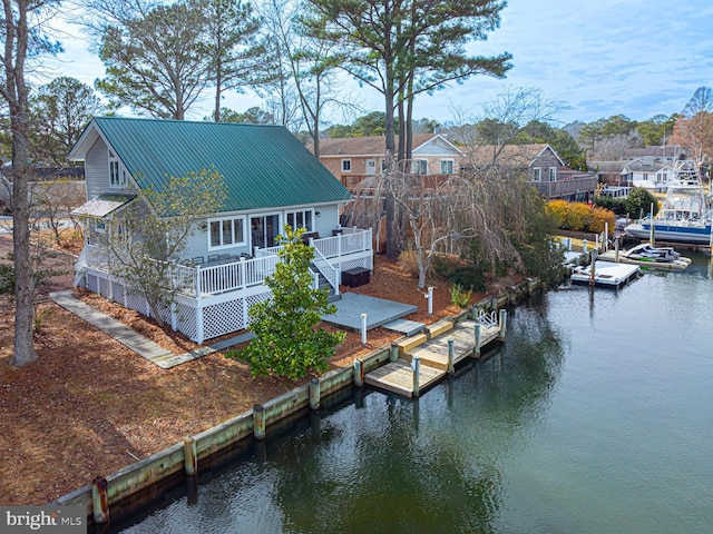 exterior space with a deck with water view