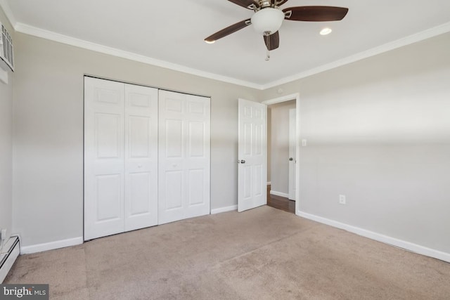 unfurnished bedroom featuring baseboards, carpet floors, ceiling fan, a closet, and crown molding