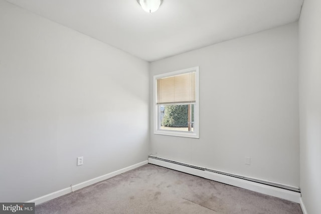 carpeted empty room featuring baseboards and baseboard heating