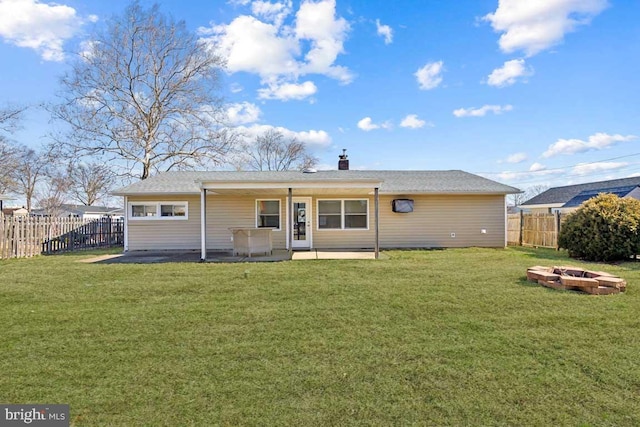 rear view of house featuring a patio area, a fenced backyard, a lawn, and an outdoor fire pit