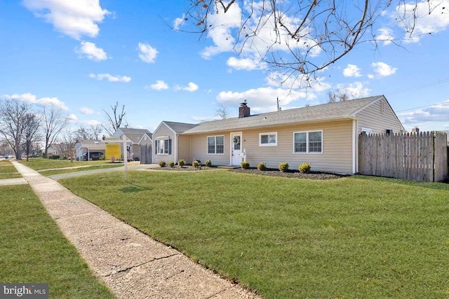 ranch-style home with a chimney, a front lawn, and fence