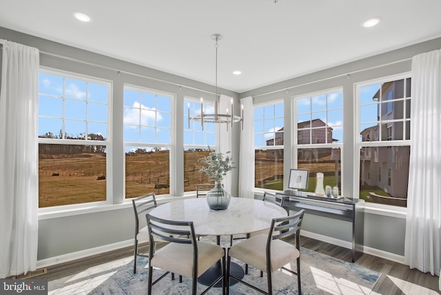 sunroom with a notable chandelier