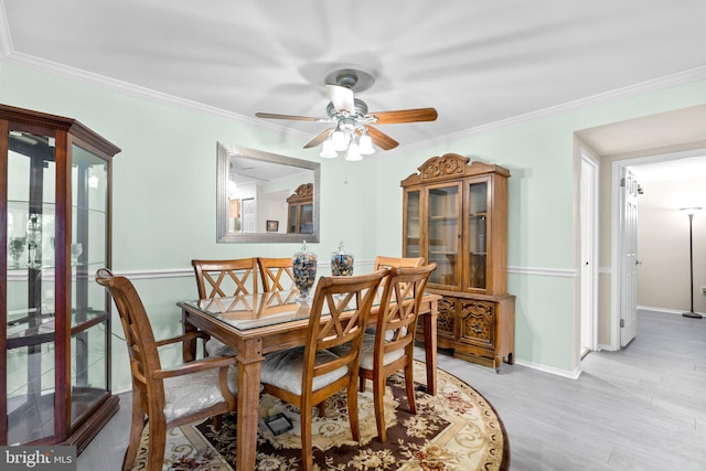 dining space featuring crown molding, ceiling fan, and light hardwood / wood-style floors