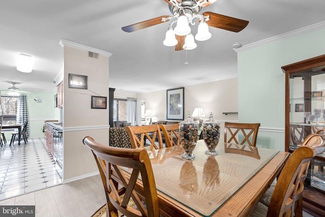 dining room featuring ornamental molding and plenty of natural light