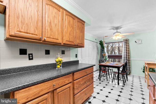 kitchen with crown molding, ceiling fan, and backsplash