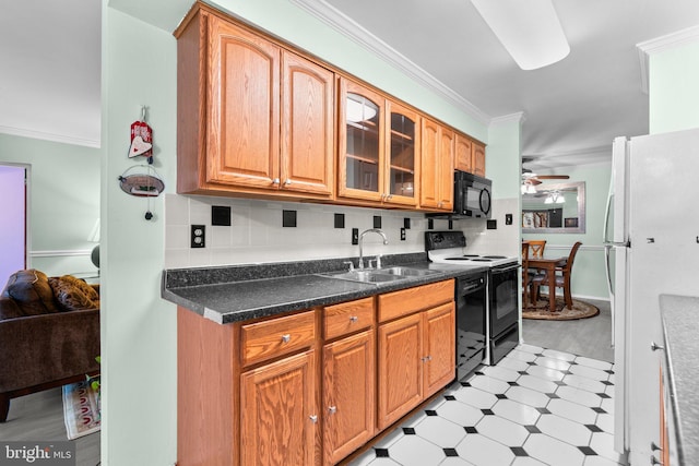 kitchen featuring ornamental molding, sink, decorative backsplash, and black appliances