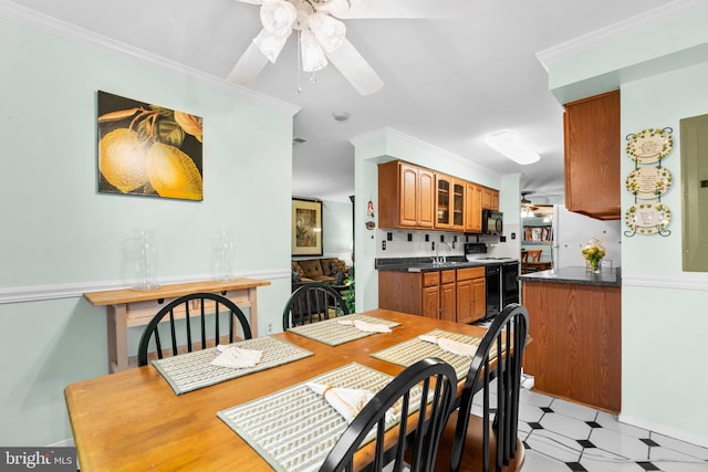 dining room with sink, ornamental molding, and ceiling fan