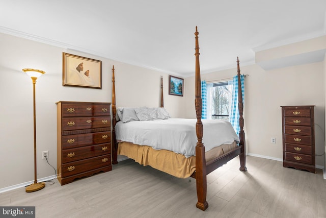 bedroom with light hardwood / wood-style flooring and ornamental molding