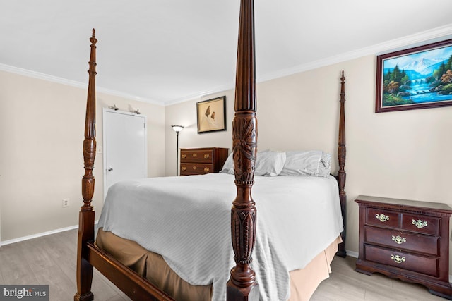 bedroom featuring ornamental molding and light wood-type flooring