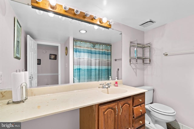 bathroom featuring vanity, curtained shower, and toilet