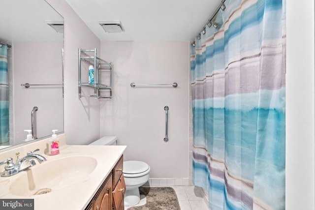 bathroom with tile patterned flooring, vanity, and toilet