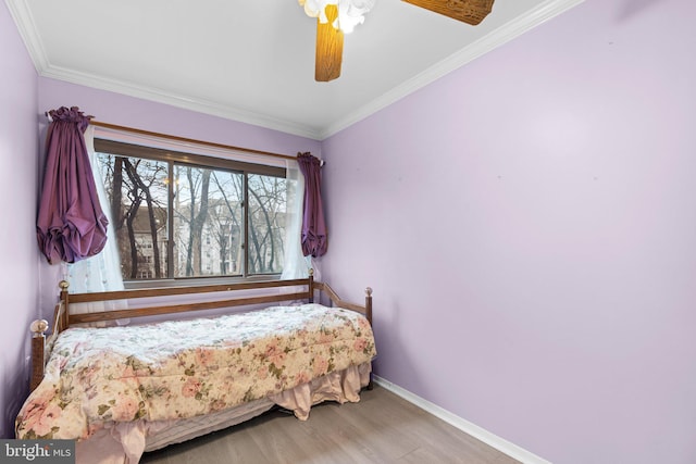 bedroom featuring hardwood / wood-style flooring, ornamental molding, and ceiling fan