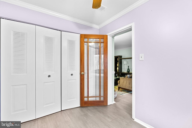 bedroom with ornamental molding, a closet, ceiling fan, and light wood-type flooring