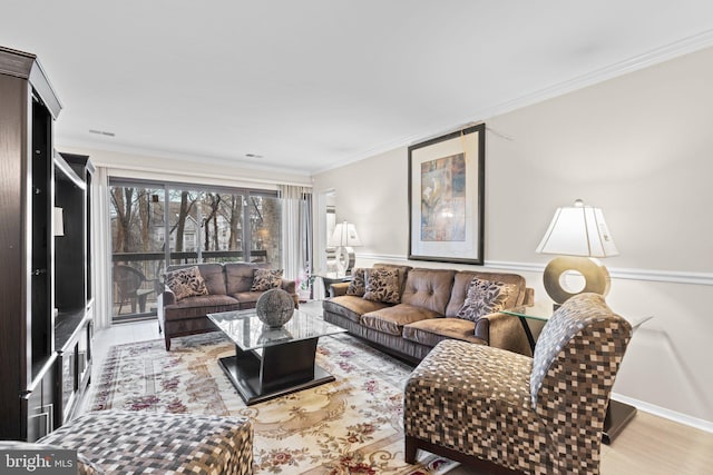 living room with ornamental molding and light hardwood / wood-style flooring