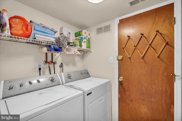 washroom featuring washer and clothes dryer