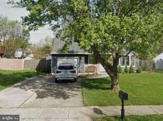 view of front of house with a garage and a front lawn