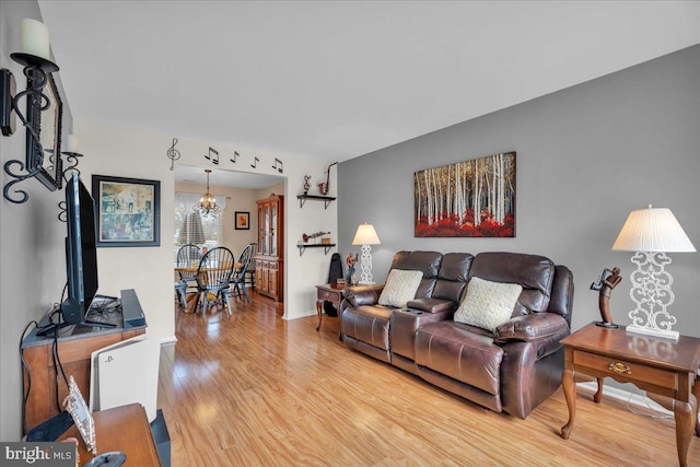 living room featuring hardwood / wood-style floors and a notable chandelier