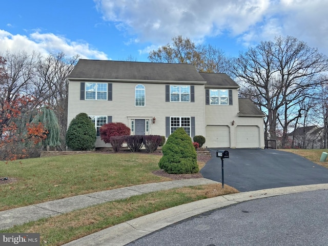 view of front of home featuring a garage and a front yard