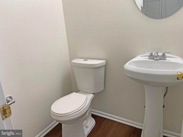 bathroom featuring sink, wood-type flooring, and toilet