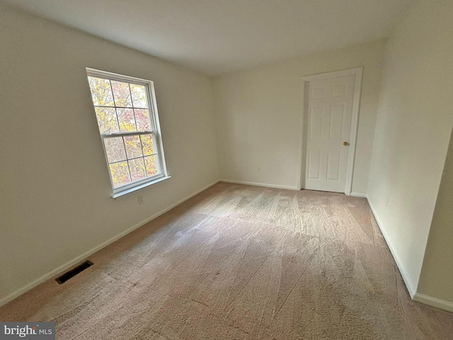 empty room featuring light colored carpet