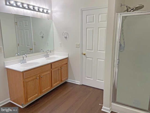 bathroom featuring an enclosed shower, hardwood / wood-style floors, and vanity