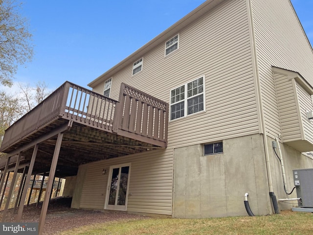 back of property with a wooden deck and central air condition unit