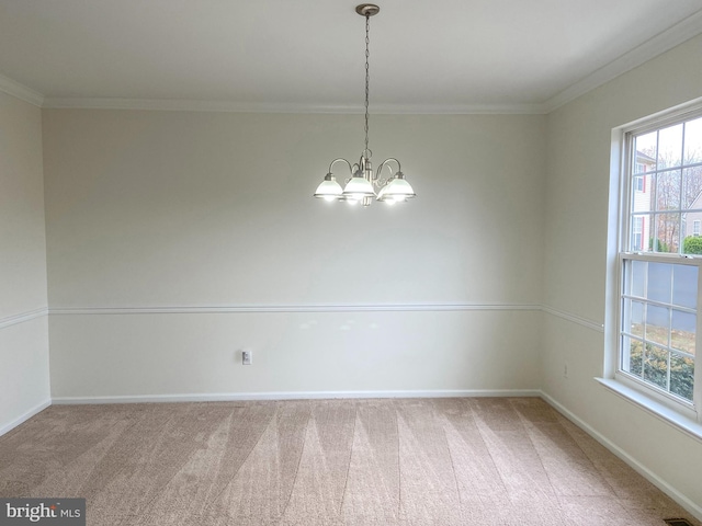 carpeted empty room with an inviting chandelier and ornamental molding