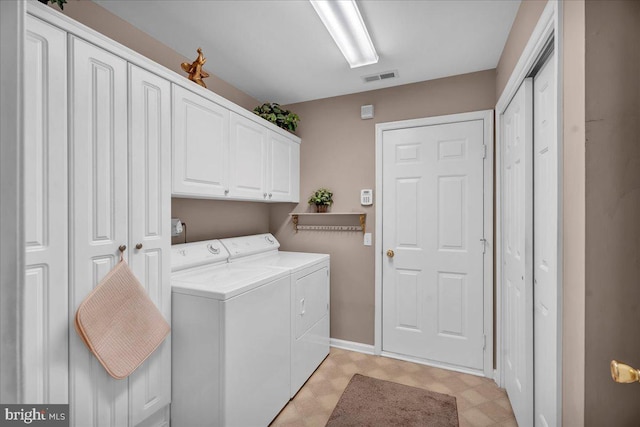 laundry area featuring cabinets and washing machine and clothes dryer