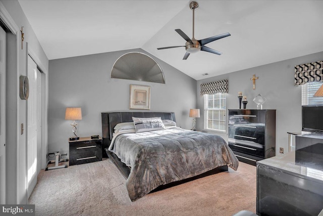 carpeted bedroom featuring vaulted ceiling, a closet, and ceiling fan