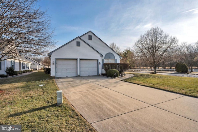 view of side of home featuring a garage and a yard