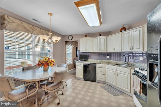 kitchen with decorative light fixtures, black dishwasher, sink, white gas range oven, and light stone countertops