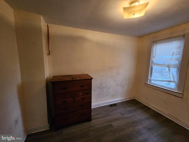 unfurnished room with dark hardwood / wood-style floors