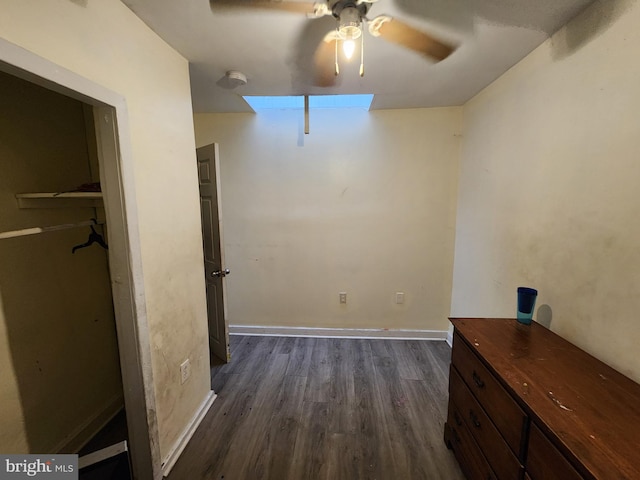 interior space with dark wood-type flooring and ceiling fan