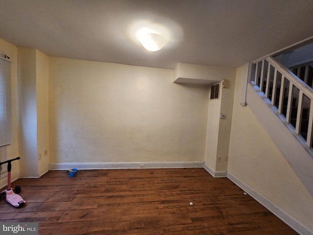 basement with dark hardwood / wood-style floors